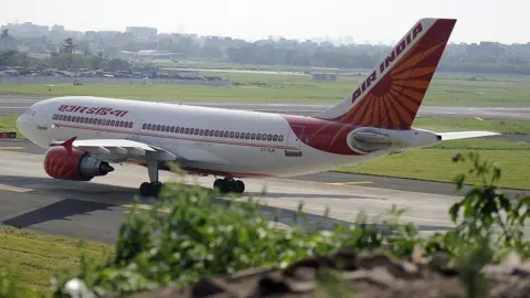 Getty Images An Indian Airlines plane taxes towards takeoff at Mumbai airport on September 27, 2009.