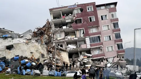 Getty Images A view of a collapsed building in Hatay, Turkiye after 7.7 and 7.6 magnitude earthquakes hits Turkiye's Hatay