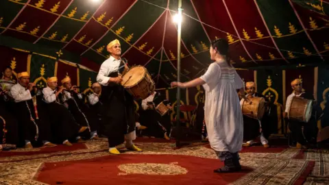 FADEL SENNA/AFP The Master Musicians of Joujouka group performs during the annual Joujouka Musical Festival in northern Morocco's Jajouka village, on May 27, 2024.