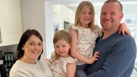 BBC Kate and Simon Powell with their two children