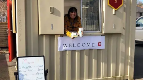 National Autistic Society worker at makeshift drive-through burger par