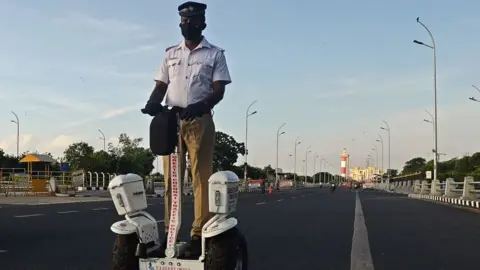 Getty Images A traffic police officer rides a self-balancing scooter during the lockdown in Chennai on May 15, 2020