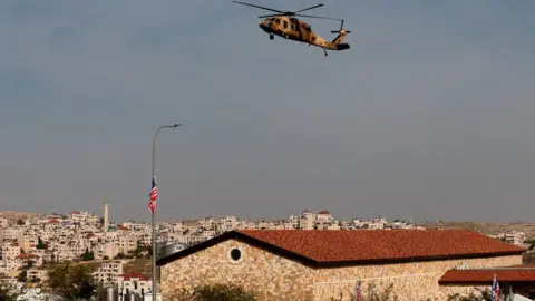 AFP A helicopter carrying US Secretary of State Mike Pompeo hovers over the Psagot winery in the Israeli-occupied West Bank (11 November 2020)