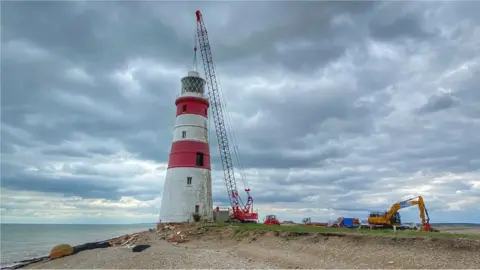 BBC After days of preparation, deconstruction work at the historic Orfordness Lighthouse is now under way