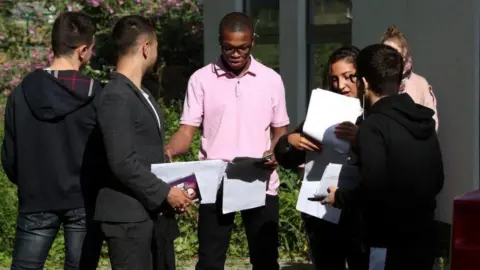 PA Media Students at Ark Academy in Wembley, north London, discuss their results