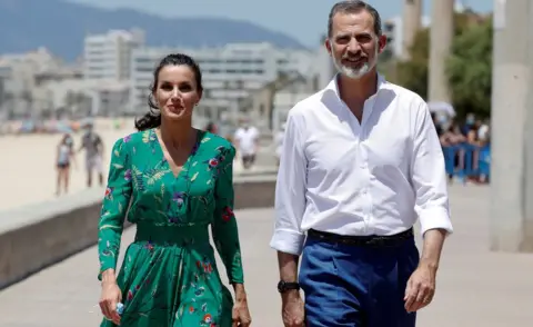 EPA Queen Letizia (L) and King Felipe VI (R) of Spain, greet tourists as they walk along El Arenal promenade in Palma de Mallorca, Spain, 25 June 2020