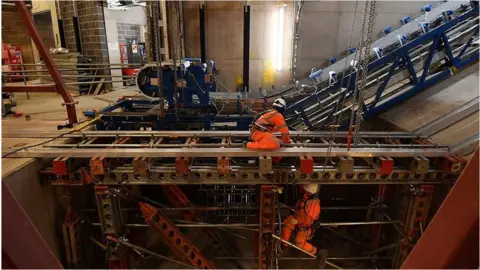 Getty Images Workmen installing escalators on Crossrail