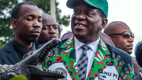 EPA President Emmerson Mnangagwa being presented with a carving of a crocodile - December 2017