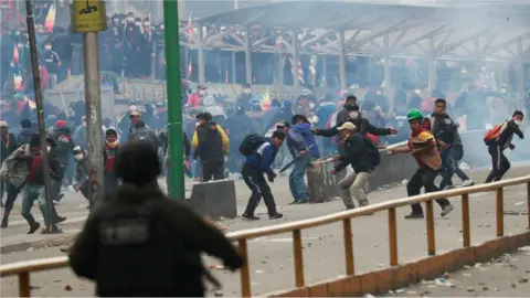 Reuters Security forces and supporters of former Bolivian President Evo Morales clash in La Paz, Bolivia, 14 November, 2019.