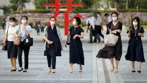 Reuters Japanese women wear masks in Tokyo