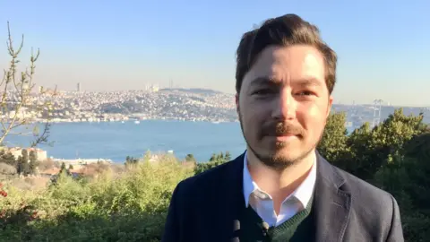 Guy in blue jacket against the Bosphorus: Can Selcuki