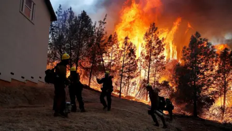 Reuters A group of U.S. Forest Service firefighters monitor a back fire while battling to save homes at the Camp Fire in Paradise