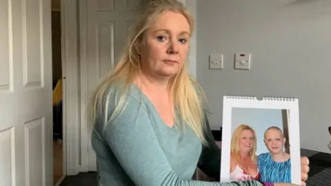 BBC Michelle Hughes with a photograph of her sister