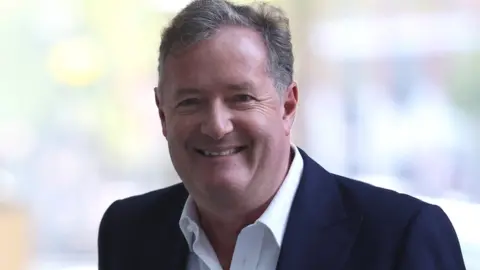 Getty Images Journalist and television presenter Piers Morgan steps out of his house, after he left his high-profile breakfast slot with the broadcaster ITV, following his long-running criticism of Prince Harry"s wife Meghan, in London, Britain