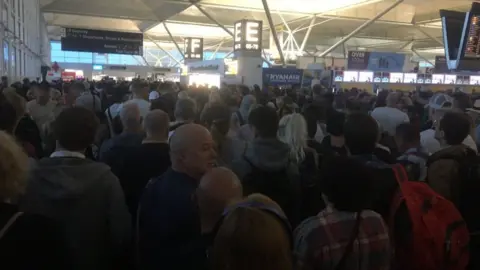 Durka Dougall Queues at Stansted Airport