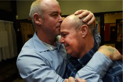 Roger Tiley Miners comfort each other at a party held following the 2015 closure of Kellingley Colliery, North Yorkshire, the last deep coal mine in the UK