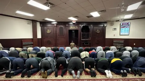 Brandon Drenon/ The BBC Dozens of Muslims pray at a Detroit mosque
