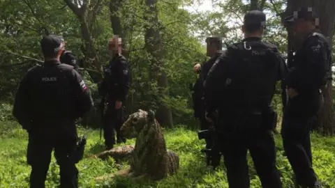 Juliet Simpson Tiger and armed police in the wood