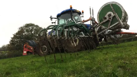 BBC A tractor spreading slurry in County Antrim