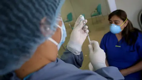 Getty Images A doctor prepares a dose of China's Sinopharm vaccine