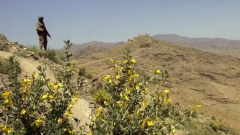 Getty Images A Pakistani army soldier guards a hilltop position at a military outpost near Wana April 11, 2007 in Pakistan"s South Waziristan tribal area near the Afghan border.