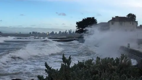 BUREAU OF METEOROLOGY VICTORIA/TWITTER A sea swell breaks over a bike path at Brighton in Melbourne