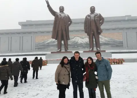 Danny Gratton Otto Warmbier and friends pose in front of statues in North Korea