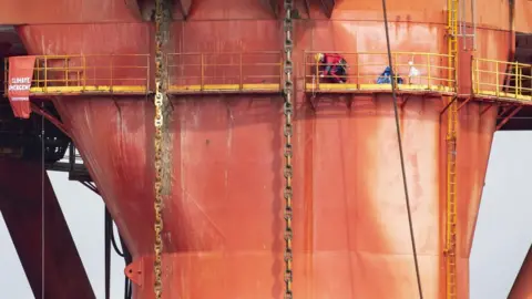 Charlie Phillips Images Greenpeace protester on rig on Friday