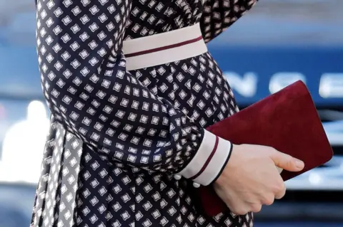 Getty Images Duchess of Cambridge clasps a Kate Spade bag against her baby bump in November 2017