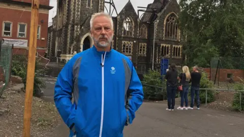 Pastor Andrew Cleverly outside the fire-damaged Bethel Community Church