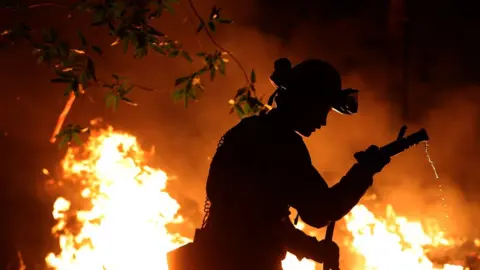 Getty Images Firefighters have scorched combustible vegetation in an attempt to control the fire