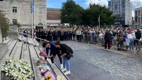 Residents leaving flowers on the steps of the Civic Centre in Southampton just after the proclamation service