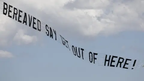 PA Media Covid-19 Bereaved Families for Justice flew this banner over the jungle with this message for Matt Hancock