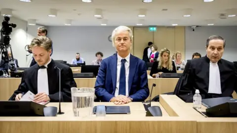 KOEN VAN WEEL/AFP Geert Wilders (C) sits in a courtroom in Schiphol, the Netherlands on July 2, 2019