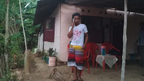 Eva Aruperes Aldi Novel Adilang at his parent’s house in Indonesia’s North Sulawesi Province.