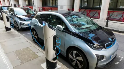 Universal Images Group  An electric car at a charging point in London