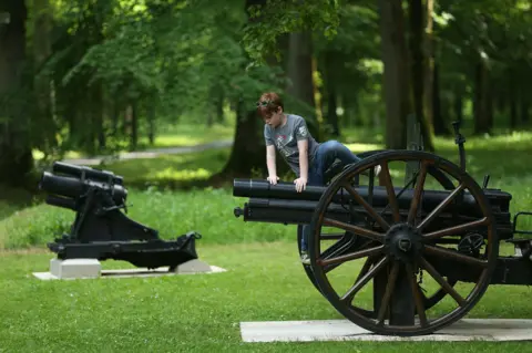 Getty Images Boy climbs on cannon on 100th anniversary at Belleau Wood