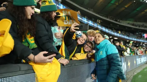 Getty Images Sam Kerr poses for a photos with fans