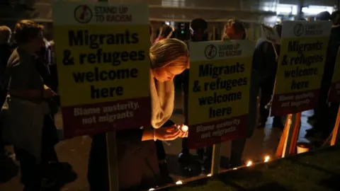 PA Media Campaigners attend a vigil outside the Home Office