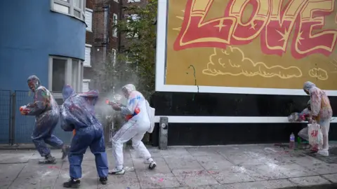 Getty Images Paint-covered revellers take part in the traditional "Jouvert" opening parade of the Notting Hill carnival