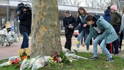AFP Teenagers were among many laying flowers at the scene of Monday's shooting in Utrecht on Tuesday