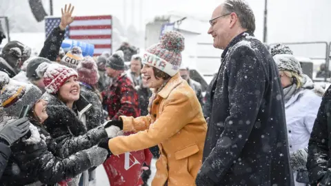 EPA Democratic Senator of Minnesota Amy Klobuchar (L) shakes hands with supporters with her husband John Bessler (R) after she announced that she is running for President
