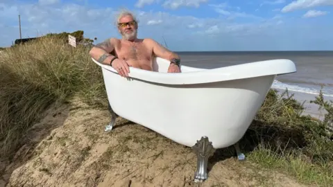 Andrew Turner/BBC Lance Martin in a bathtub