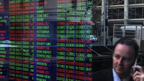 Getty Images Man on phone in reflection of screen