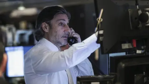 Getty Images Traders and financial professionals work ahead of the closing bell on the floor of the New York Stock Exchange (NYSE), March 26, 2018 in New York City.