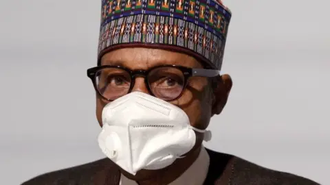 Getty Images Nigeria's President Muhammadu Buhari poses before the opening session of the Summit on the Financing of African Economies on May 18, 2021 in Paris