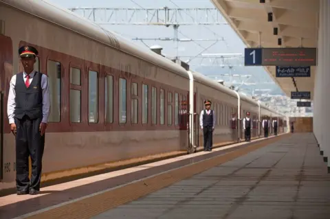 AFP/Getty Images Chinese employees of the Addis Ababa / Djibouti train line stand at the Feri train station in Addis Ababa on 24 September 2016.