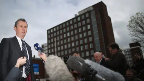 Getty Images Nigel Evans surrounded by the press outside court