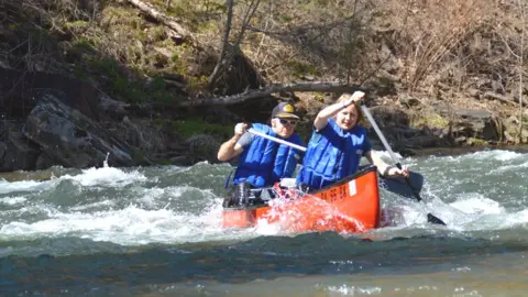 Penn State Outing Club Students manoeuvre a canoe on a river
