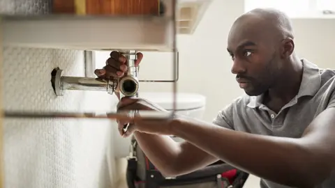 Getty Images Plumber at work